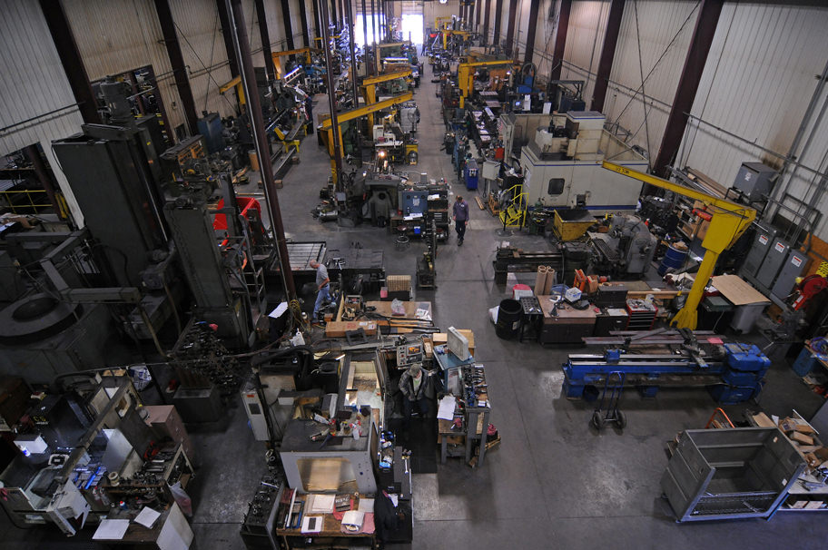 A high shot looking over workers and machines in the shop